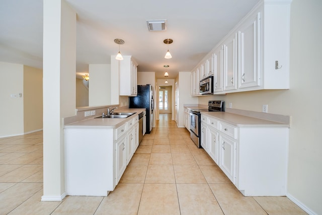18426 Stark Point Ct, Humble, TX 77346 - kitchen featuring appliances with stainless steel finishes, light tile patterned floors, white cabinetry, and light countertops
