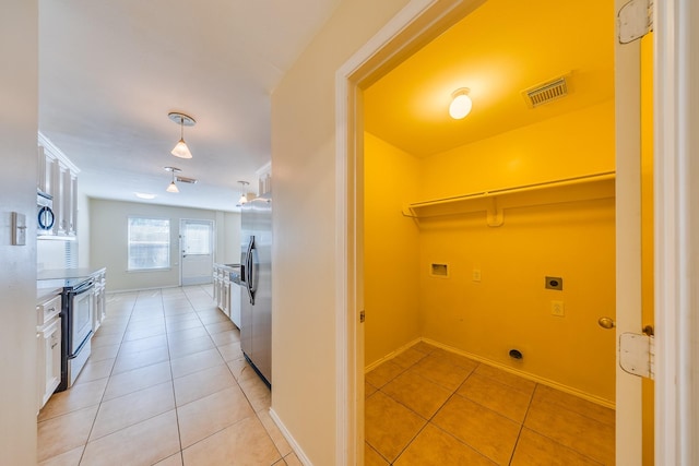 18426 Stark Point Ct, Humble, TX 77346 - washroom with electric dryer hookup, hookup for a washing machine, and light tile patterned floors