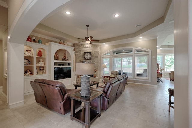 69 W Shore Ln, Montgomery, TX 77356 - living area with a ceiling fan, a raised ceiling, recessed lighting, crown molding, and arched walkways