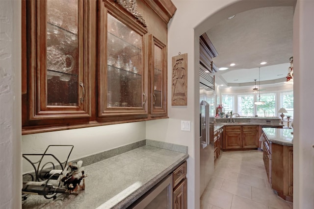 69 W Shore Ln, Montgomery, TX 77356 - bar featuring arched walkways, a raised ceiling, light tile patterned floors, hanging light fixtures, and recessed lighting