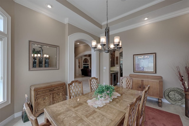 69 W Shore Ln, Montgomery, TX 77356 - dining area featuring arched walkways, a chandelier, crown molding, recessed lighting, and beverage cooler