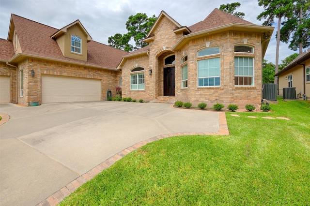 69 W Shore Ln, Montgomery, TX 77356 - view of front of property with brick siding, a shingled roof, and concrete driveway