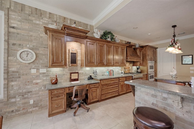 69 W Shore Ln, Montgomery, TX 77356 - kitchen featuring stainless steel appliances, custom exhaust hood, crown molding, brown cabinetry, and pendant lighting