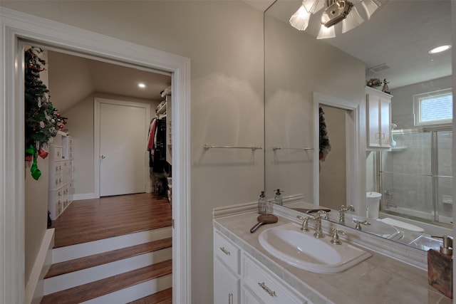 69 W Shore Ln, Montgomery, TX 77356 - full bathroom featuring vanity, combined bath / shower with glass door, recessed lighting, wood finished floors, and vaulted ceiling