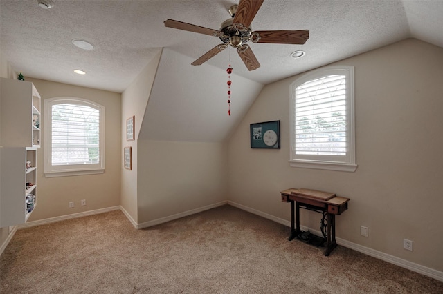 69 W Shore Ln, Montgomery, TX 77356 - additional living space featuring lofted ceiling, carpet floors, a textured ceiling, and a ceiling fan