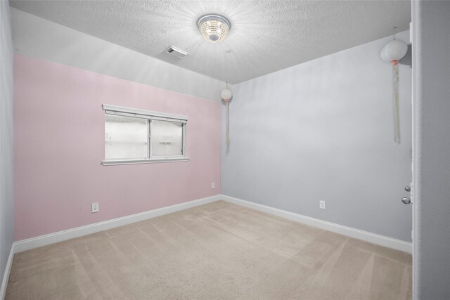 13315 Lake Passage Ln, Houston, TX 77044 - empty room featuring light colored carpet and a textured ceiling