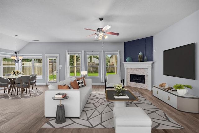13315 Lake Passage Ln, Houston, TX 77044 - living room featuring wood finished floors, plenty of natural light, ceiling fan, a fireplace, and lofted ceiling