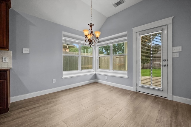 13315 Lake Passage Ln, Houston, TX 77044 - unfurnished dining area with a chandelier, vaulted ceiling, healthy amount of natural light, and wood finished floors