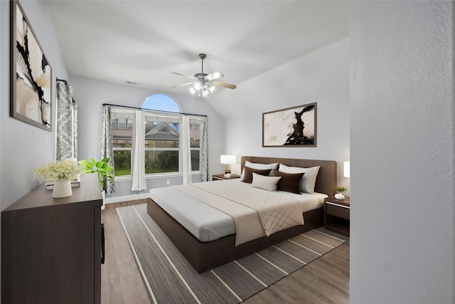 13315 Lake Passage Ln, Houston, TX 77044 - bedroom with wood finished floors, vaulted ceiling, and a ceiling fan