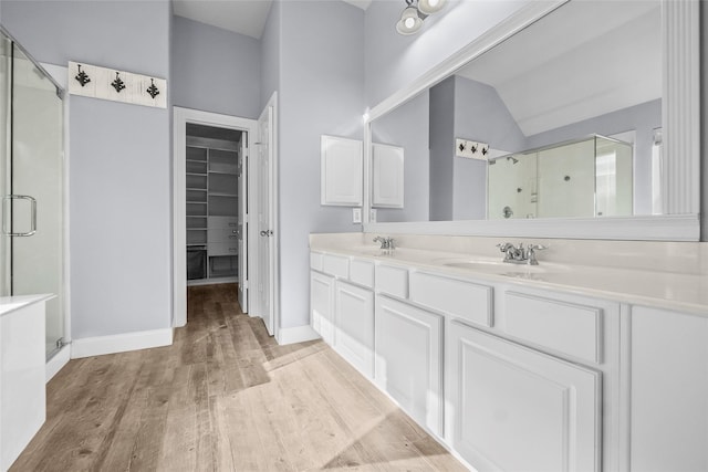 13315 Lake Passage Ln, Houston, TX 77044 - full bath with a stall shower, lofted ceiling, double vanity, wood finished floors, and a spacious closet