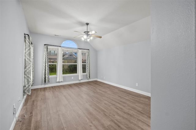 13315 Lake Passage Ln, Houston, TX 77044 - empty room featuring ceiling fan, wood finished floors, and vaulted ceiling