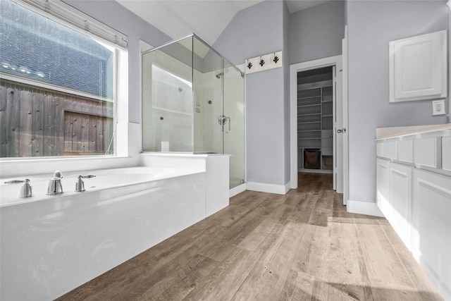 13315 Lake Passage Ln, Houston, TX 77044 - bathroom with a shower stall, wood finished floors, a garden tub, a spacious closet, and vanity