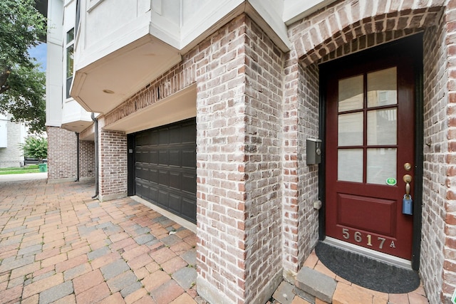 5617 Kiam St Unit A, Houston, TX 77007 - view of exterior entry with brick siding and an attached garage