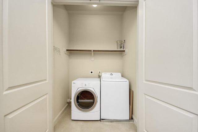 5617 Kiam St Unit A, Houston, TX 77007 - laundry room with light tile patterned floors and washer and clothes dryer