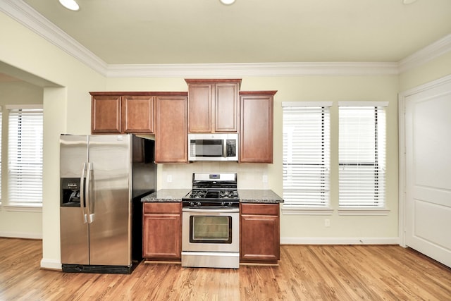 5617 Kiam St Unit A, Houston, TX 77007 - kitchen featuring stainless steel appliances, dark stone countertops, crown molding, light wood-style floors, and brown cabinets