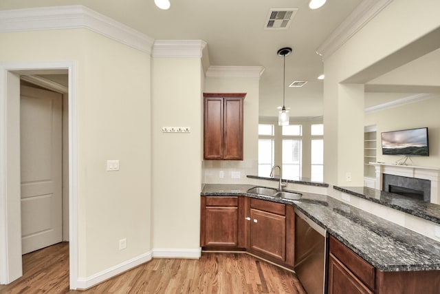 5617 Kiam St Unit A, Houston, TX 77007 - kitchen featuring stainless steel dishwasher, light wood-type flooring, dark stone countertops, a premium fireplace, and ornamental molding
