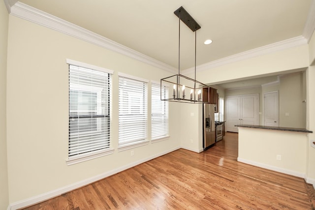 5617 Kiam St Unit A, Houston, TX 77007 - unfurnished dining area with a chandelier, ornamental molding, light wood-style floors, and recessed lighting