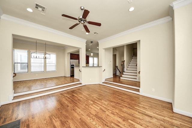 5617 Kiam St Unit A, Houston, TX 77007 - unfurnished living room featuring light wood-style flooring, crown molding, ceiling fan, stairs, and recessed lighting