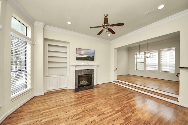 5617 Kiam St Unit A, Houston, TX 77007 - unfurnished living room with wood finished floors, ornamental molding, a fireplace, ceiling fan, and built in shelves