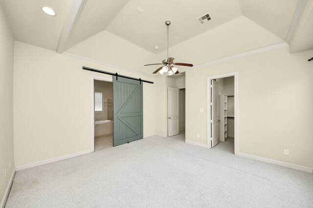 5617 Kiam St Unit A, Houston, TX 77007 - unfurnished bedroom with light carpet, a barn door, a spacious closet, ceiling fan, and crown molding