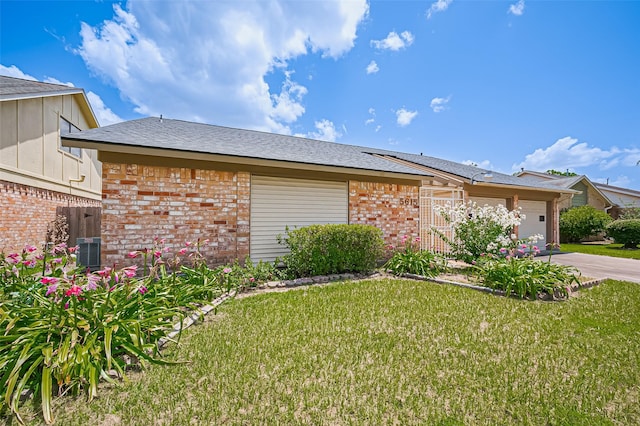 5615 Briarwood Forest Dr, Houston, TX 77088 - view of front of house with a garage, brick siding, driveway, and a front yard