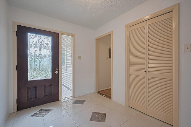 5615 Briarwood Forest Dr, Houston, TX 77088 - foyer entrance with light tile patterned floors and a textured ceiling