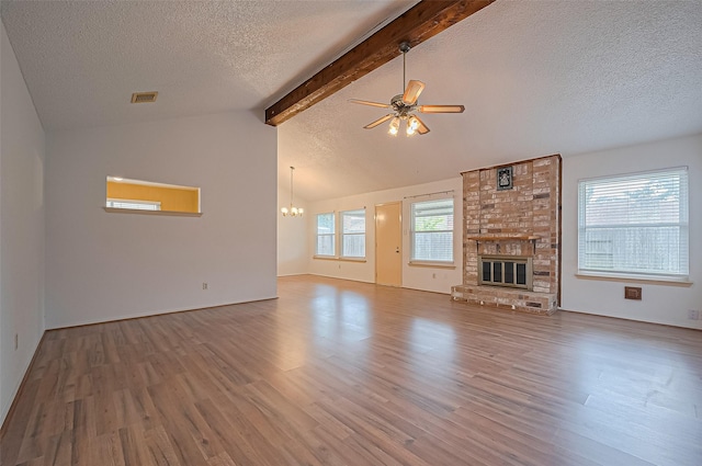 5615 Briarwood Forest Dr, Houston, TX 77088 - unfurnished living room with a textured ceiling, wood finished floors, a chandelier, ceiling fan, and a brick fireplace