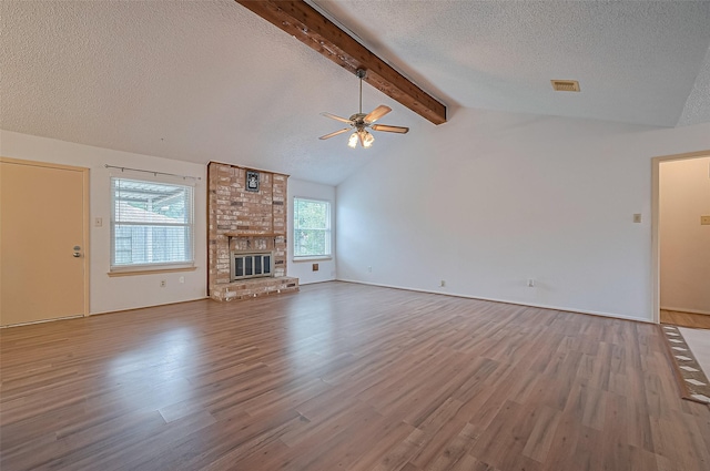 5615 Briarwood Forest Dr, Houston, TX 77088 - unfurnished living room featuring a ceiling fan, a textured ceiling, wood finished floors, and a brick fireplace