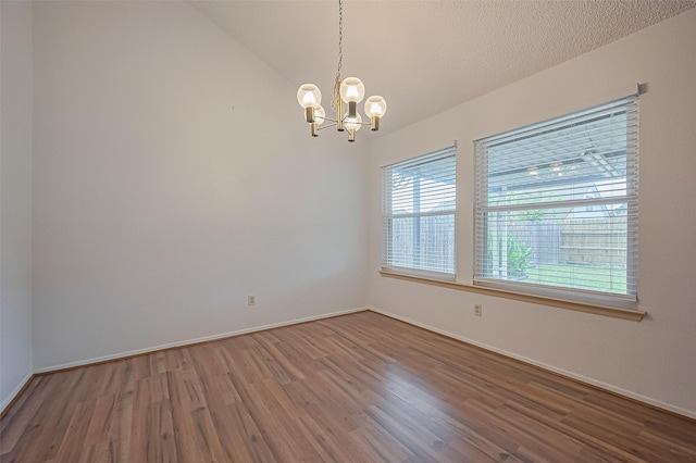 5615 Briarwood Forest Dr, Houston, TX 77088 - spare room with a chandelier, wood finished floors, and lofted ceiling