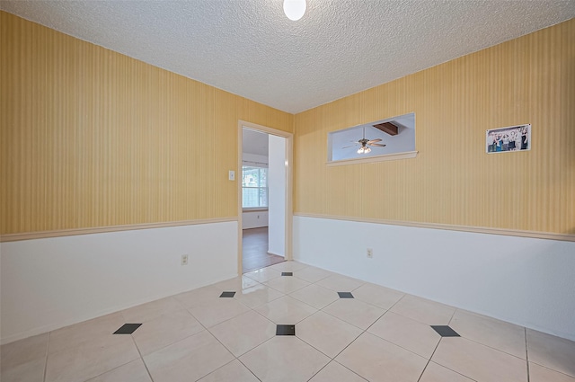 5615 Briarwood Forest Dr, Houston, TX 77088 - tiled empty room featuring a textured ceiling and a ceiling fan