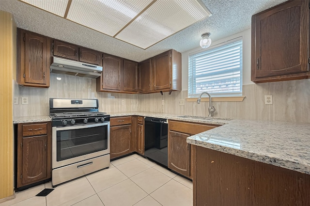 5615 Briarwood Forest Dr, Houston, TX 77088 - kitchen featuring under cabinet range hood, stainless steel range with gas cooktop, dishwasher, light tile patterned flooring, and dark brown cabinetry