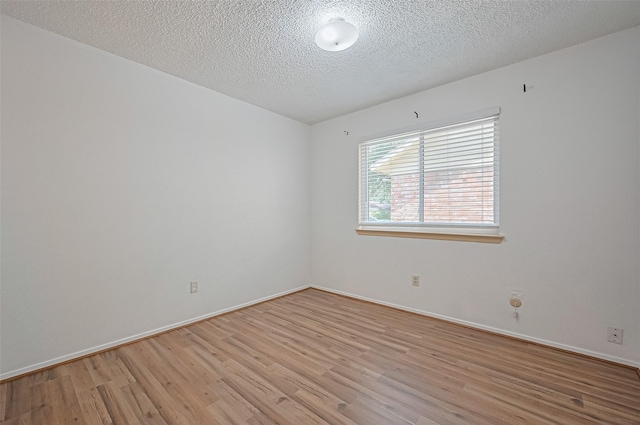 5615 Briarwood Forest Dr, Houston, TX 77088 - empty room with light wood-type flooring and a textured ceiling