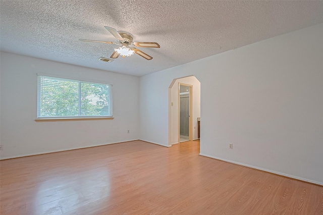 5615 Briarwood Forest Dr, Houston, TX 77088 - unfurnished room with light wood-style floors, arched walkways, a textured ceiling, and ceiling fan