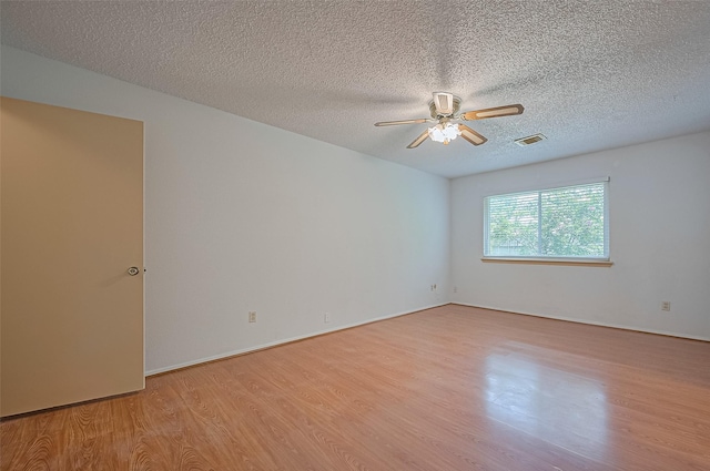 5615 Briarwood Forest Dr, Houston, TX 77088 - spare room featuring light wood-type flooring, ceiling fan, and a textured ceiling