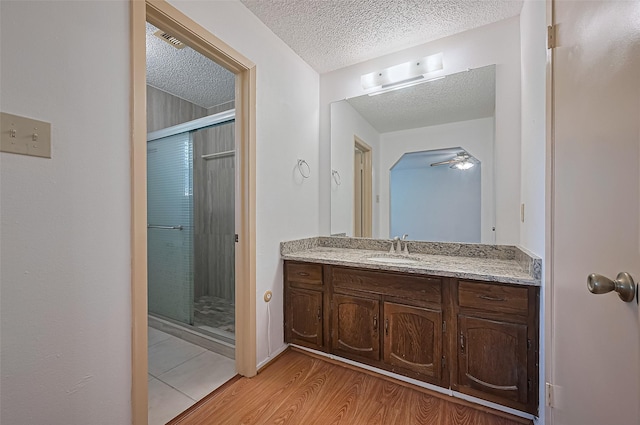 5615 Briarwood Forest Dr, Houston, TX 77088 - full bath with a textured ceiling, a stall shower, vanity, and wood finished floors