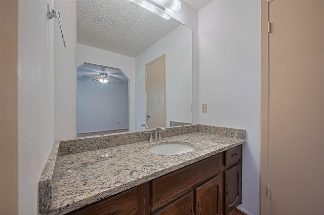 5615 Briarwood Forest Dr, Houston, TX 77088 - bathroom with a textured ceiling, vanity, and a ceiling fan