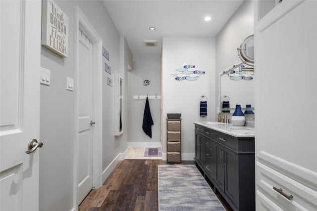5411 Holly View Dr, Houston, TX 77091 - bathroom featuring vanity, wood finished floors, and recessed lighting