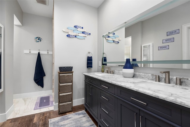 5411 Holly View Dr, Houston, TX 77091 - bathroom featuring double vanity and wood finished floors