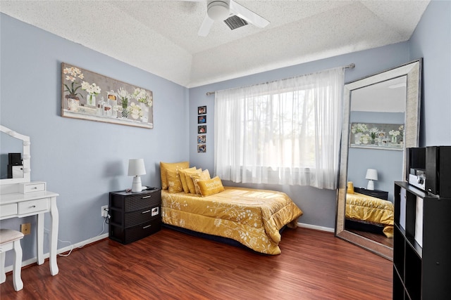 5411 Holly View Dr, Houston, TX 77091 - bedroom with dark wood-style floors, ceiling fan, and a textured ceiling