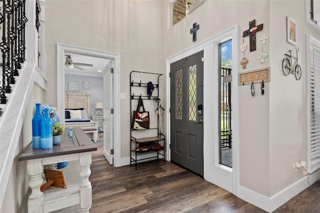 5411 Holly View Dr, Houston, TX 77091 - foyer with dark wood finished floors, ceiling fan, a high ceiling, and stairs