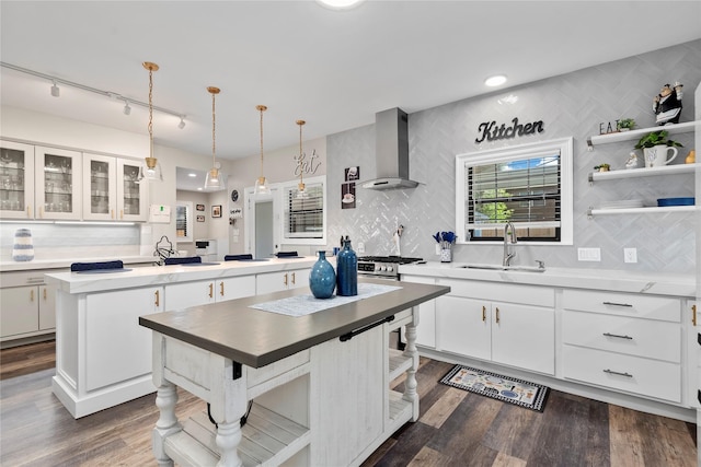 5411 Holly View Dr, Houston, TX 77091 - kitchen featuring a center island, tasteful backsplash, extractor fan, white cabinets, and recessed lighting