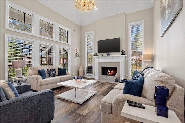 5411 Holly View Dr, Houston, TX 77091 - living room featuring wood finished floors, a chandelier, a fireplace with flush hearth, and a towering ceiling
