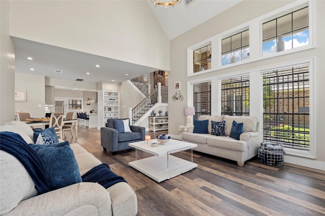 5411 Holly View Dr, Houston, TX 77091 - living area with high vaulted ceiling, stairway, wood finished floors, plenty of natural light, and recessed lighting