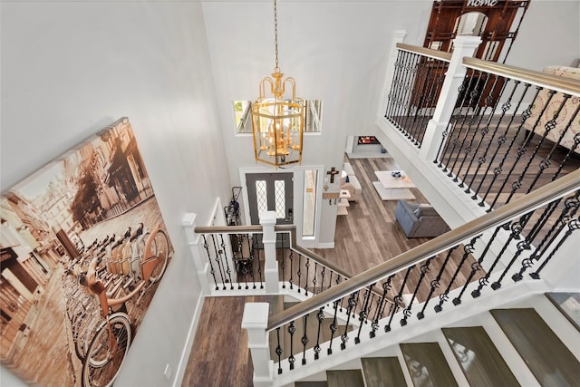 5411 Holly View Dr, Houston, TX 77091 - staircase with wood finished floors, a high ceiling, and a chandelier