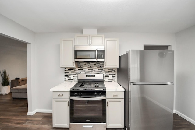 3111 Tanglebriar Dr, Pasadena, TX 77503 - kitchen with stainless steel appliances, backsplash, dark wood-style flooring, and white cabinetry