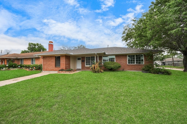 3111 Tanglebriar Dr, Pasadena, TX 77503 - ranch-style house with a front lawn, a chimney, and brick siding
