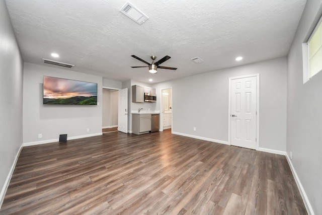 3111 Tanglebriar Dr, Pasadena, TX 77503 - unfurnished living room featuring a ceiling fan, dark wood finished floors, recessed lighting, and a textured ceiling