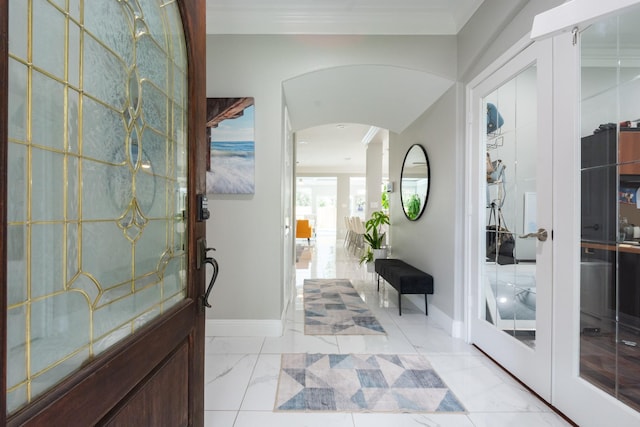 9910 Tulip, Conroe, TX 77385 - entrance foyer featuring arched walkways and light marble finish floors