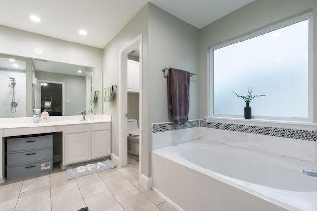 9910 Tulip, Conroe, TX 77385 - full bath featuring a bath, vanity, tile patterned flooring, and recessed lighting