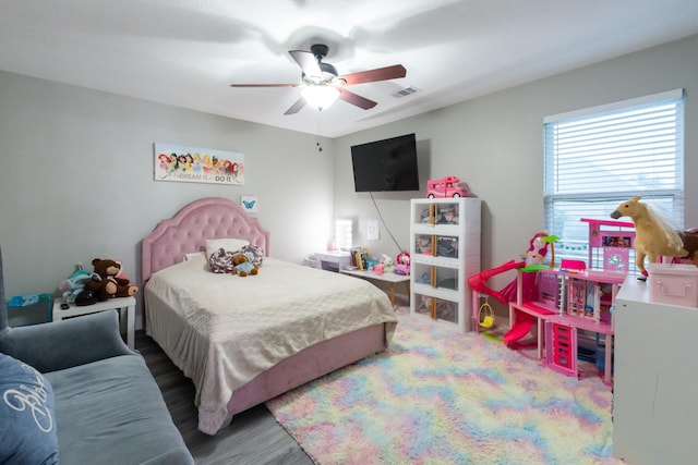 9910 Tulip, Conroe, TX 77385 - bedroom with wood finished floors and ceiling fan